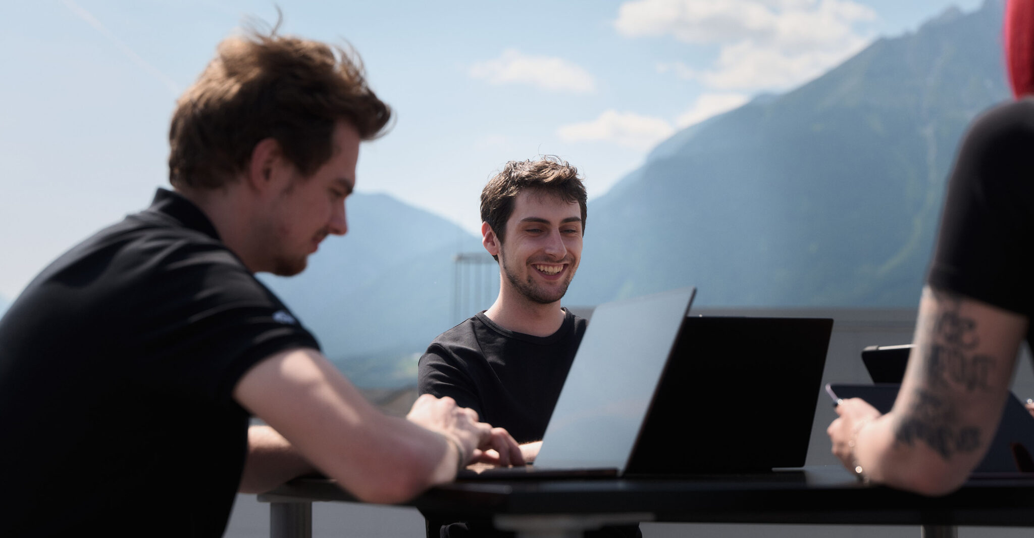 Group of three IT workers collaborating on a project.