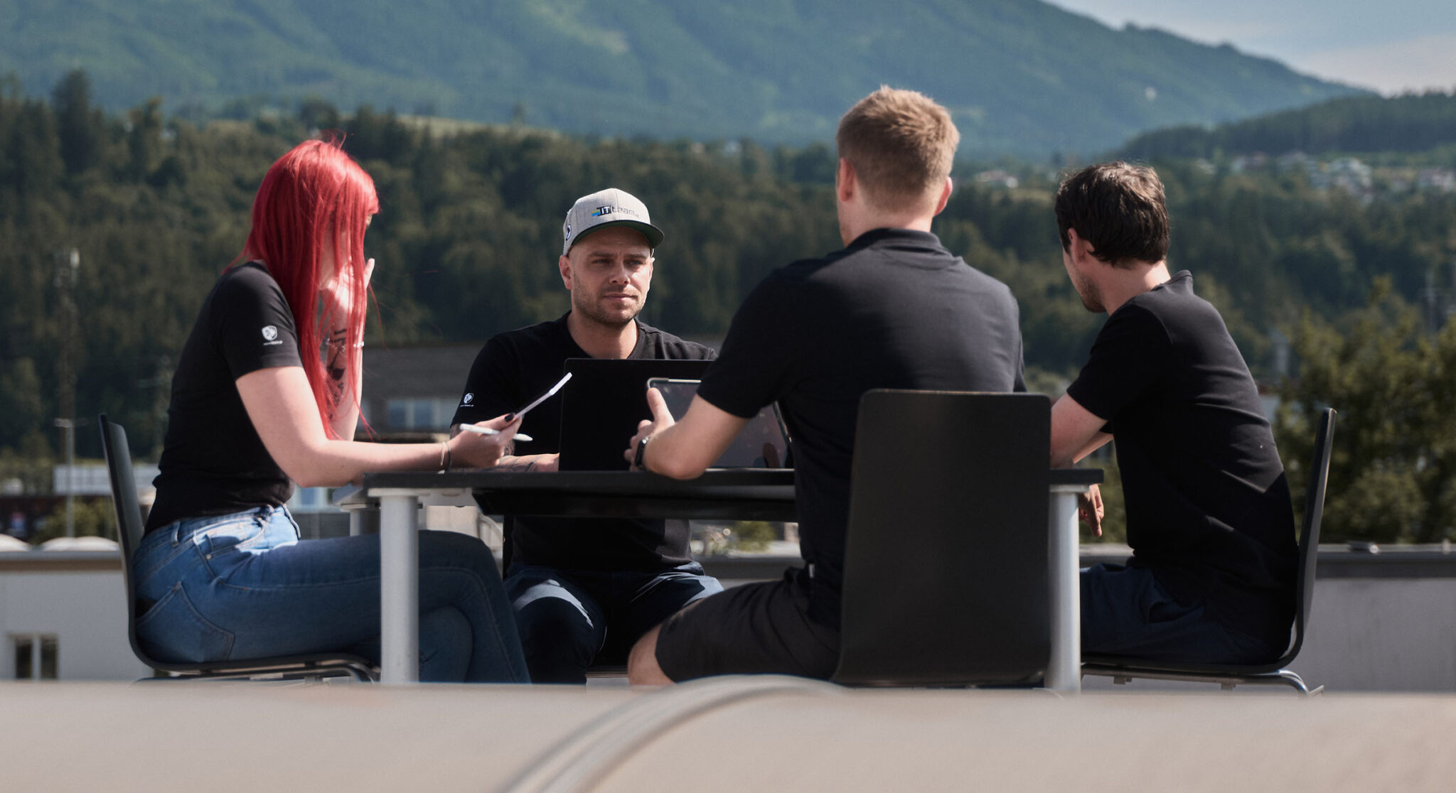 Group of three IT workers collaborating on a project.